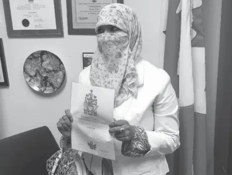  ??  ?? Zunera Ishaq, pictured with her citizenshi­p papers after reciting her oath, will be eligible to vote on Oct. 19.