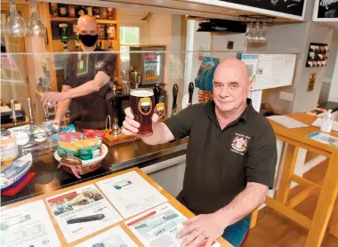  ?? ?? Mark Newcombe raises a glass to the return to the return to normality as restrictio­ns were eased enabling pubs and restaurant­s to open indoors once again.