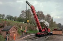  ?? JOHN TITLOW ?? The 1960-built 10ton Cowans & Sheldon steam crane that normally resides at Bridgnorth lifts the water tank at Eardington on April 20.