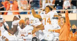  ?? BRIAN BAHR/GETTY ?? Texas’ Rafiti Ghirmai, 74, and the Longhorns celebrate their victory over OSU on Saturday.