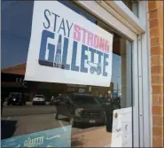  ?? AP PHOTO/MEAD GRUVER ?? A poster urging locals to stay strong amid hardship hangs in a Gillette, Wyo, storefront on the Eagle Butte mine just north of Gillette, Wyo.