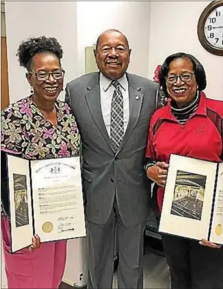  ?? SUBMITTED PHOTO ?? Sharon Jackson and Sheila Moore, identical twins who have worked together at the Coatesvill­e VA Medical Center since 1973, hold citations they received from state Rep. Harry Lewis Jr., R-74.