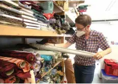  ??  ?? An employee sorts fabrics in the sewing room of the Salzburg Festival. — AFP photos