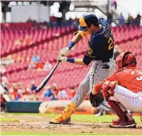  ?? AARON DOSTER/ASSOCIATED PRESS ?? The Milwaukee Brewers’ Christian Yelich hits a ground-rule double during the first inning of Wednesday’s game against the Reds in Cincinnati. Yelich hit for the cycle for the third time in his career.