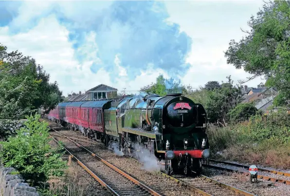  ?? BARRY MARTIN ?? Merchant Navy Pacific No. 35018 British India Line passes Horrocksfo­rd Junction with West Coast Railways’ ‘The Pendle Dalesman’ on September 27.