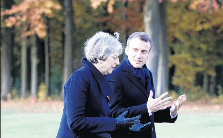  ?? FRANCOIS MORI/AP ?? British Prime Minister Theresa May and French President Emmanuel Macron visit the World War I-era Thiepval Memorial to the Missing of the Somme on Nov. 9.