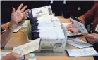  ?? MATT SLOCUM/AP ?? Election workers process mail-in and absentee ballots on Nov. 4 in West Chester, Pa.