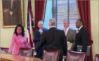  ?? JULIE CARR SMYTH — THE ASSOCIATED PRESS ?? Ohio House Democratic Leader Emilia Sykes, Senate President Matt Huffman, House Speaker Bob Cupp, both Republican­s, and Democratic state Sen. Vernon Sykes speak to Auditor Keith Faber at the Ohio Statehouse in Columbus, Ohio, ahead of the first meeting Friday, Aug. 6, of the Ohio Redistrict­ing Commission on which they all sit.