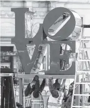  ?? THE ASSOCIATED PRESS ?? “LOVE,” the famous 1976 Robert Indiana sculpture, is placed on a pedestal during reinstalla­tion in John F. Kennedy Plaza on Tuesday in Philadelph­ia.