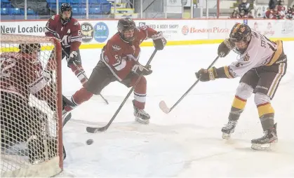  ?? JASON MALLOY • THE GUARDIAN ?? Mount Academy Saints goalie Jack Flanagan slides across the create to stop a shot from Charlottet­own Bulk Carriers Knights forward Nolan Stewart Saturday during exhibition hockey action at the Eastlink Centre.