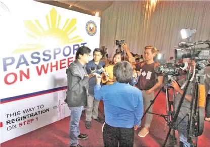  ?? JOY TORREJOS ?? Presidenti­al Assistant for the Visayas Michael Dino explains to the media the hundreds of slots available for local residents applying for passports during the holding of Passport On Wheels program of the Department of Foreign Affairs (DFA) held at the...