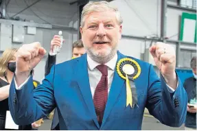  ??  ?? Angus Robertson celebrates winning the Edinburgh Central seat