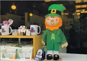  ?? SAL PIZARRO — STAFF ?? Lucky the Leprechaun stands in the service window of Voyager coffee at San Pedro Square Market on Thursday as part of a San Jose Downtown Associatio­n promotion.