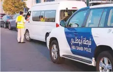  ?? Courtesy: Abu Dhabi Police ?? Abu Dhabi Police conducting checks on vehicles suspected ■ of carrying passengers in illegal carpooling.