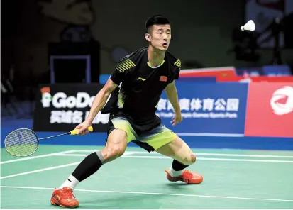  ??  ?? Chen Long of China hits a shot against Khosit Phetpradab of Thailand during their second-round match at the badminton world championsh­ips in Nanjing, capital of east China’s Jiangsu Province, yesterday. The Olympic champion won 21-16, 21-11. — AFP