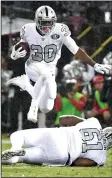  ?? DOUG DURAN/TRIBUNE NEWS SERVICE ?? Raiders RB Jalen Richard jumps over teammate Rodney Hudson as he runs for a first down against the Chiefs in Oakland on Thursday.
