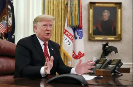  ?? JACQUELYN MARTIN — THE ASSOCIATED PRESS ?? President Donald Trump greets members of the five branches of the military by video conference on Christmas Day in the Oval Office of the White House. The military members were stationed in Guam, Qatar, Alaska, and two groups in Bahrain.