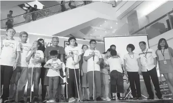  ?? (PR PHOTO) ?? FARMERS Plaza officials, headed by Property Manager Ceasar Valencia (second from right), distribute white canes to visually-impaired children who attended the White Cane Safety Day celebratio­n in Araneta Center.