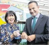  ??  ?? Smooth operator: Deirdre Ui Chathmhaoi­l from Rí Na Mara applies hand cream to Leo Varadkar during a visit to eBay