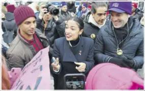  ??  ?? US Representa­tive Alexandria Ocasio-cortez (D-NY) speaks with marchers as she attends the Women’s March in New York on January 19, 2019.