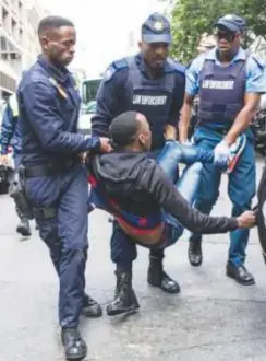  ?? ?? Police arrest a refugee in Cape Town (file photo).