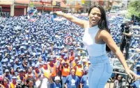  ??  ?? ANY COLOUR: Bucie Nqwiliso entertains the blue crowd during a DA march through Johannesbu­rg for jobs on January 27 this year