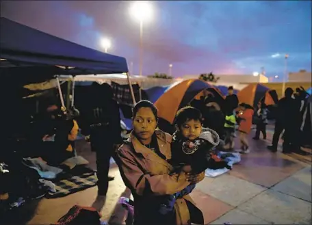  ?? Gary Coronado Los Angeles Times ?? CENTRAL AMERICANS seeking asylum in the U.S. gather at an encampment near El Chaparral Port of Entry in Tijuana in May.