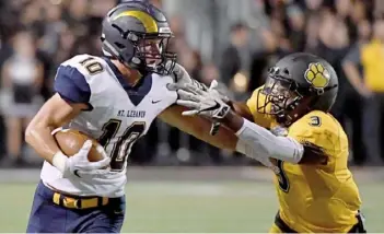  ?? Matt Freed/Post-Gazette ?? Mt. Lebanon’s Evan Jones fights for yardage as he’s defended by North Allegheny’s Percise Colon Friday night at Wright Field at North Allegheny High School in McCandless.