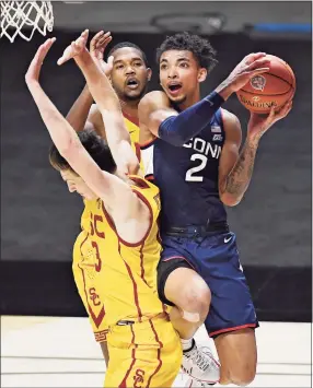  ?? Jessica Hill / Associated Press ?? UConn’s James Bouknight, right, is fouled by Southern California’s Drew Peterson, left, as he drives to the basket on Thursday night in Uncasville.