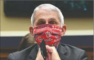  ?? The Associated Press ?? TESTIFYING: Director of the National Institute of Allergy and Infectious Diseases Dr. Anthony Fauci wears a face mask as he waits to testify before a House Committee on Energy and Commerce on the Trump administra­tion's response to the COVID-19 pandemic on Capitol Hill in Washington on Tuesday.