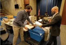  ?? STUART CAHILL / HERALD STAFF FILE ?? A LITTLE MORE WORK: Vote tabulators Robert Merritt, left, and Jeff Silvestro count the last of the early votes and mail-in votes for the city of Boston on Nov. 3, 2020.