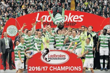  ?? Picture: REUTERS ?? WE ARE THE CHAMPS: Celtic’s Efe Ambrose celebrates with teammates after winning the Scottish Premiershi­p yesterday