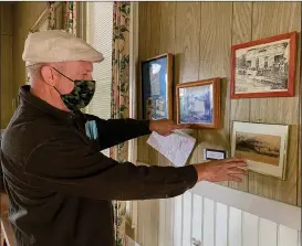  ?? Courtesy photo / Union Democrat ?? Aronos House Secretary Dennis Wiebe, of Jamestown, ontuesday points to old photos of the Aronos Clubhouse from 1898 and 1901.