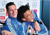  ??  ?? Germany’s midfielder Leroy Sane (right) and Julian Draxler laugh at joke during a press conference in Berlin yesterday. (AFP)