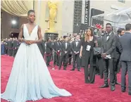  ??  ?? Lupita Nyong’o in a pale blue Prada dress at the Oscars in Los Angeles in March 2014.