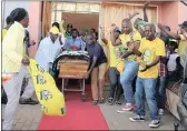  ??  ?? ANC members escort the coffin of Xolani Ngcobo, who was attacked and killed in Inchanga last week.