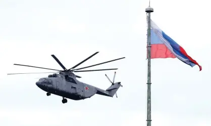  ??  ?? A military helicopter in St Petersburg during a dress rehearsal of the upcoming Victory Day air show. Photograph: Alexander Demianchuk/Tass