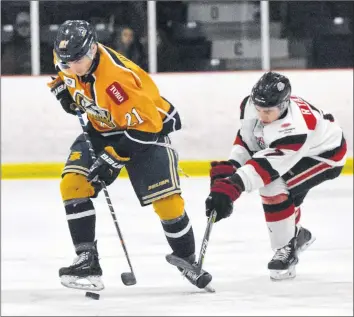  ?? TINA COMEAU ?? Pictou County Crusher Brayden Ryan extends his reach to try and get the puck away from Mariner Thomas Hillier during a Jan. 19 matchup between the two teams.