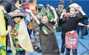  ?? TAIMY ALVAREZ/SUN SENTINEL ?? From left, Hebrew Academy Community School students, Nate Vaknin, Yona Krinsky, Shmuli Smith and classmates dance Tuesday during their celebratio­n of the Jewish holiday of Purim in Margate. Purim commemorat­es the saving of the Jewish people from Haman, who was planning to kill all the Jews.