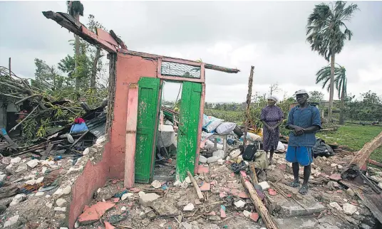  ?? Pictures / AP ?? Saintanor Dutervil and his wife were among thousands in Haiti whose homes were destroyed by Hurricane Matthew.