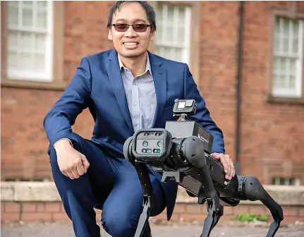  ?? ?? Associate professor Taufiq Asyhari BCU with the robot dog forest ranger