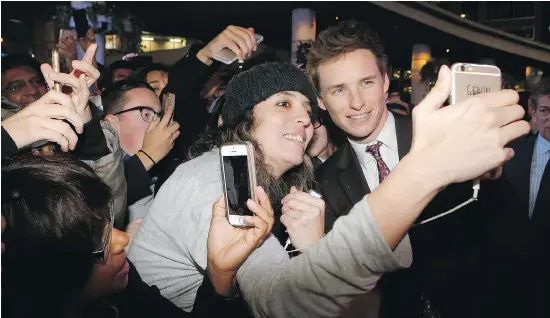  ?? MICHAEL PEAKE / POSTMEDIA NETWORK ?? Eddie Redmayne, star of the new Harry Potter prequel, is mobbed by fans on the red carpet at Yonge Dundas Square in Toronto earlier this month.