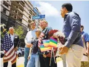  ?? K.C. ALFRED U-T ?? City leaders and activists hang wreaths on four street signs along Harvey Milk Street in Hillcrest on Sunday, the late gay rights activist’s birthday.