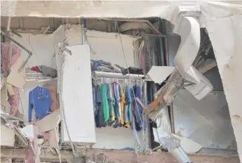  ?? SCOTT OLSON/GETTY IMAGES ?? Clothes still hang in a closet in the collapsed building in Davenport, Iowa, on Monday.