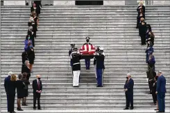  ?? J. SCOTT APPLEWHITE / ASSOCIATED PRESS ?? ◄ Justice Ruth Bader Ginsburg’s coffin is carried out by a joint services military honor guard after lying in state at the U.S. Capitol on Friday. The steps are lined by female members of Congress.