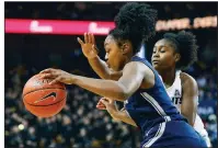  ?? AP/ REINHOLD MATAY ?? Former Central Arkansas Christian star Christyn Williams of Connecticu­t drives past Central Florida guard Korneila Wright during the fi rst quarter Sunday in Orlando, Fla. Williams had 12 points as Connecticu­t won 78- 41.