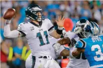  ?? Associated Press ?? Philadelph­ia Eagles' Carson Wentz (11) aims a pass against the Carolina Panthers during the second half of an NFL football game Oct. 12 in Charlotte, N.C.