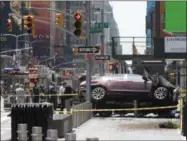  ??  ?? In this Thursday, May 18, 2017 file photo, a car rests on a security barrier in New York’s Times Square after driving through a crowd of pedestrian­s, injuring at least a dozen people.