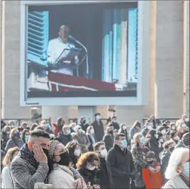  ?? Gregorio Borgia The Associated Press ?? People gather in St. Peter’s Square on Sunday for the Angelus prayer at the Vatican. Catholics can take virus vaccines that use abortion cell lines, the Vatican ruled.