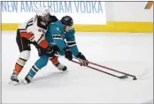  ?? JOSIE LEPE — THE ASSOCIATED PRESS ?? Anaheim Ducks left wing Max Comtois (44) reaches for the puck around San Jose Sharks left wing John Leonard (43) during the second period Saturday in San Jose.